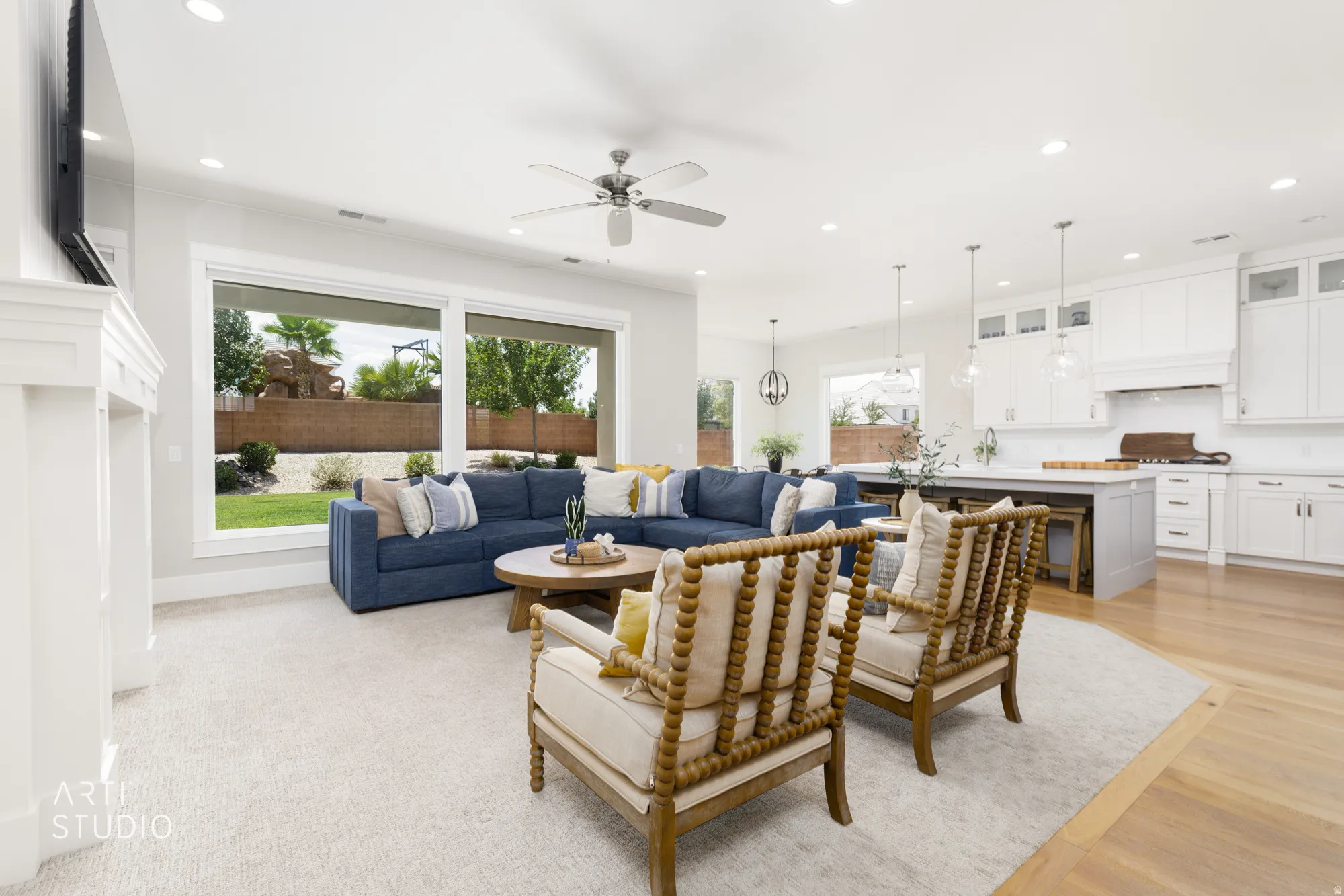 Open-concept living space featuring a fireplace, recessed lighting, and a ceiling fan