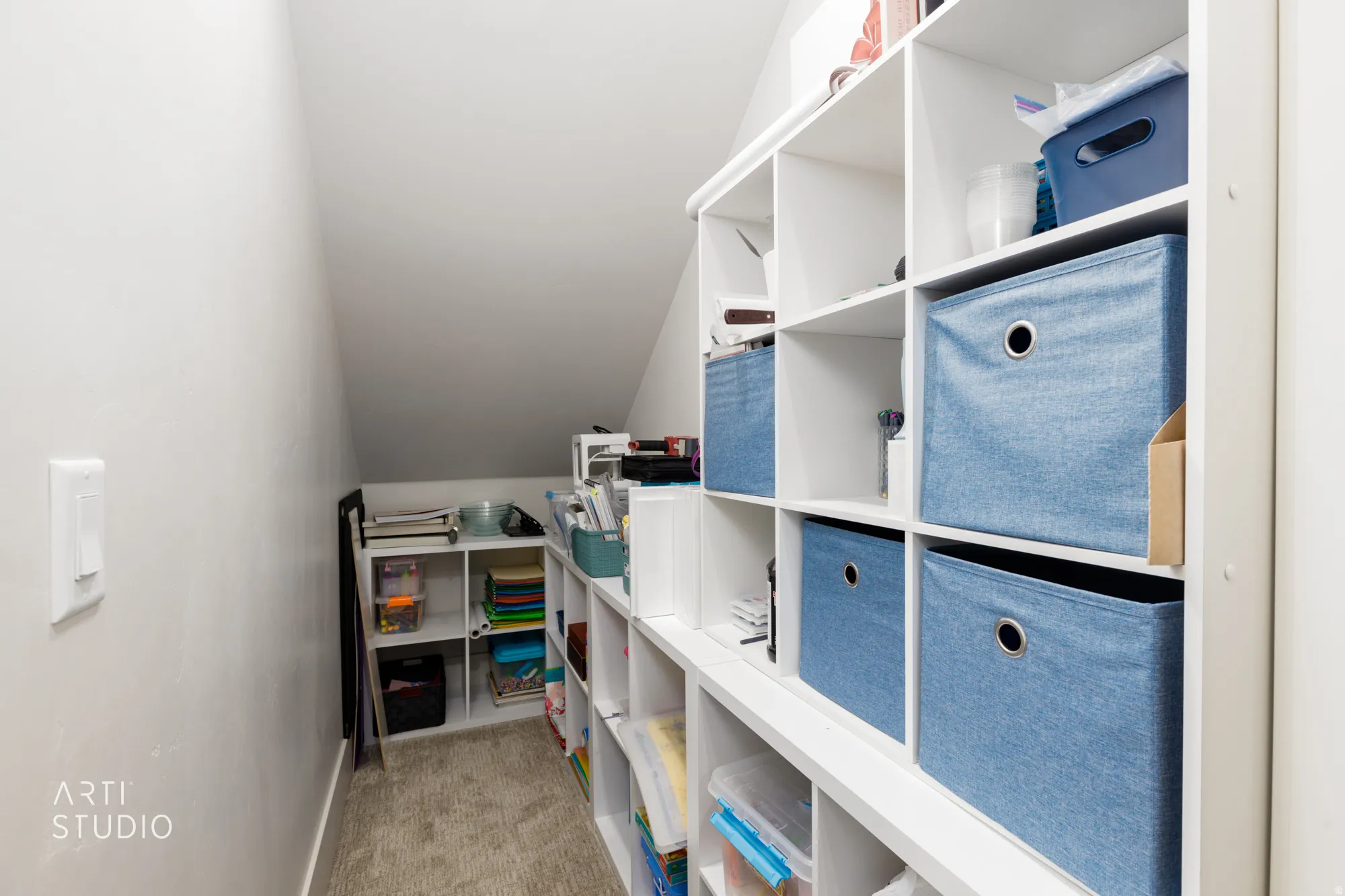 Integrated white shelving units providing extensive storage options