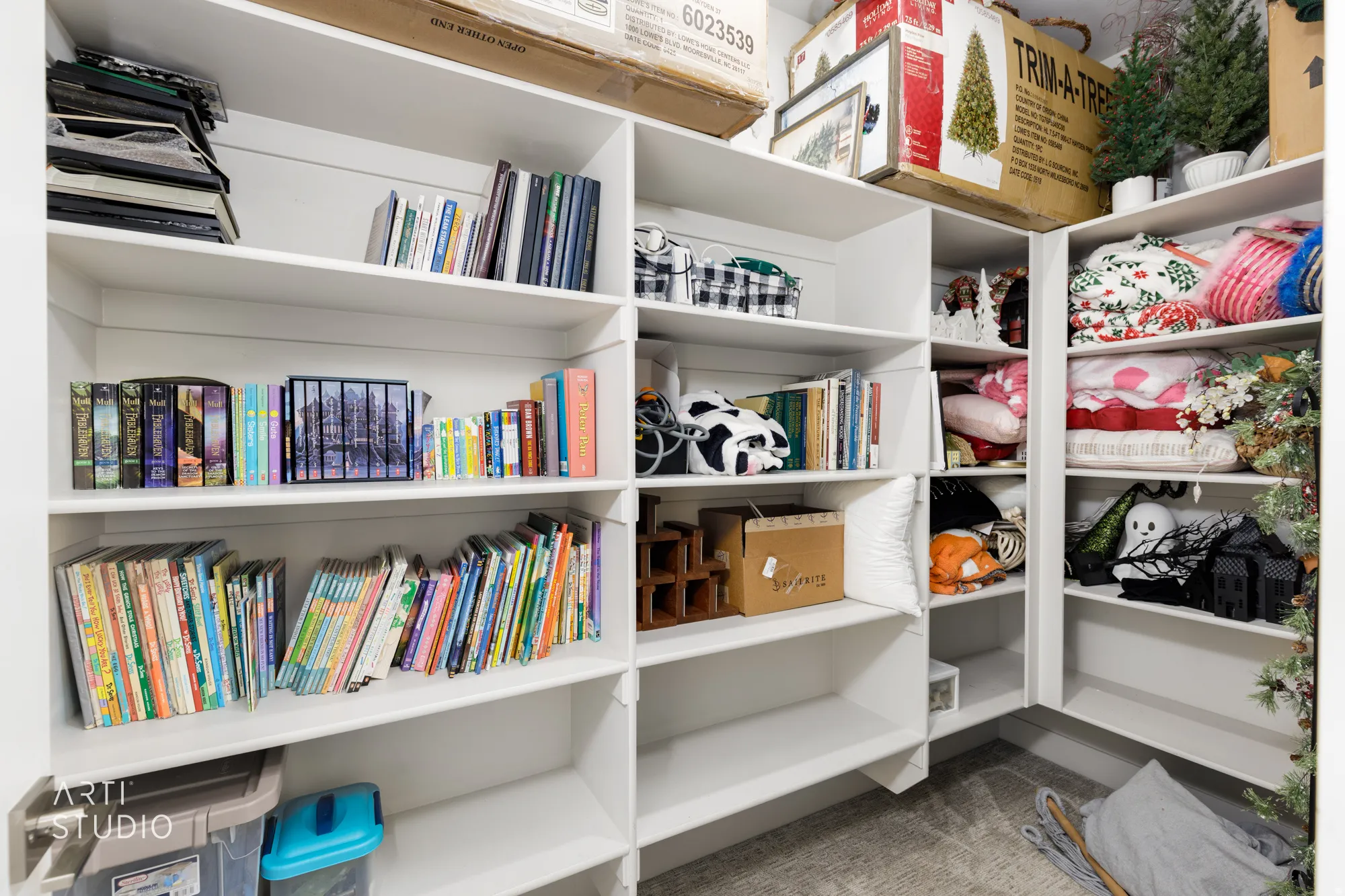Built-in white shelving system featuring adjustable shelves and corner configurations for versatile storage