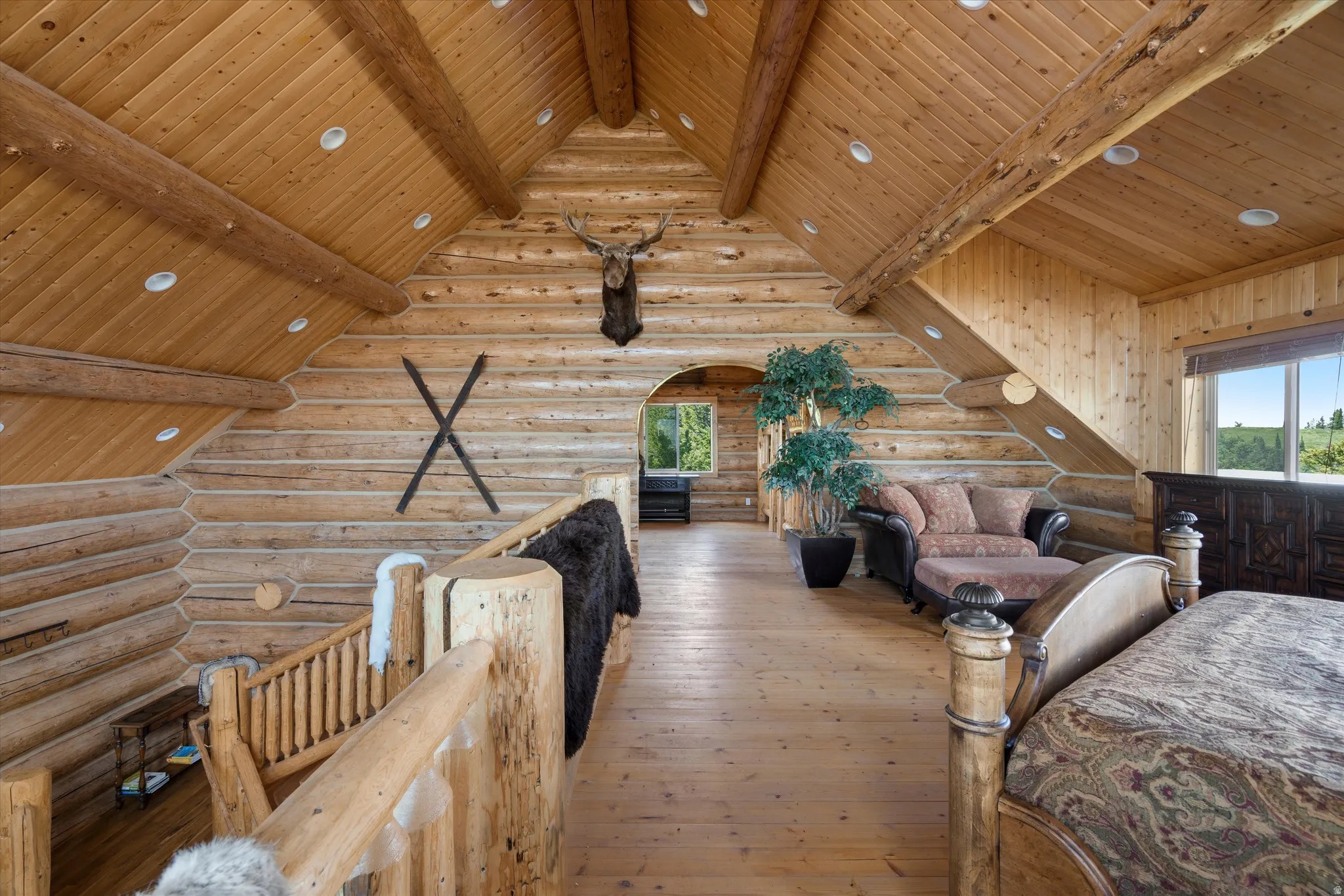 Vaulted wood-paneled ceiling with exposed wood beams and recessed lighting
