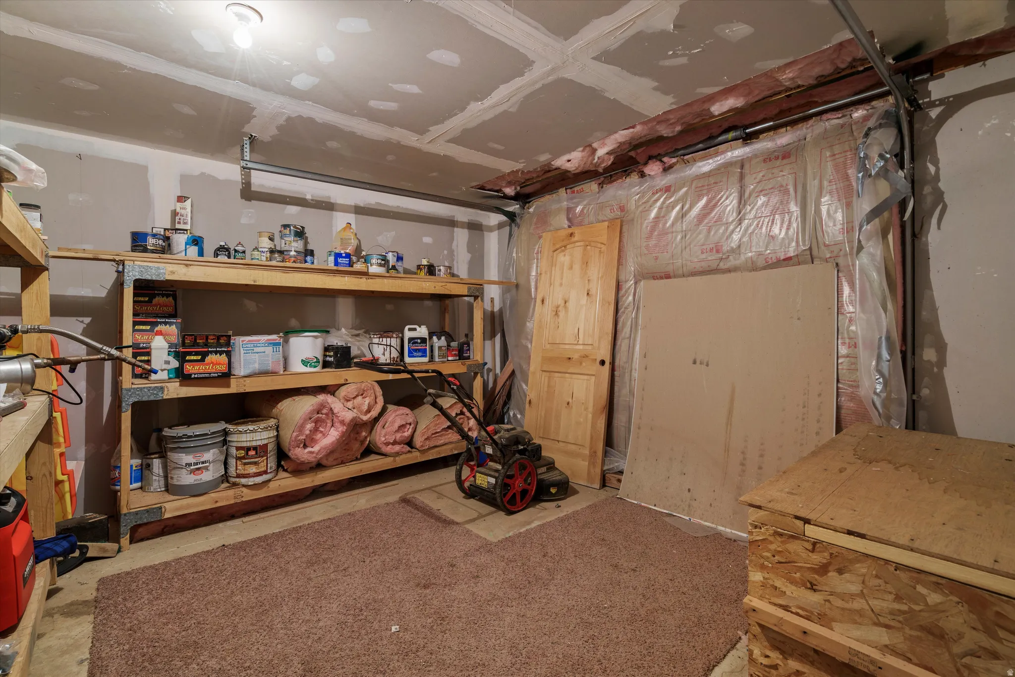 Unfinished basement area with exposed ceiling joists and rough-in insulation