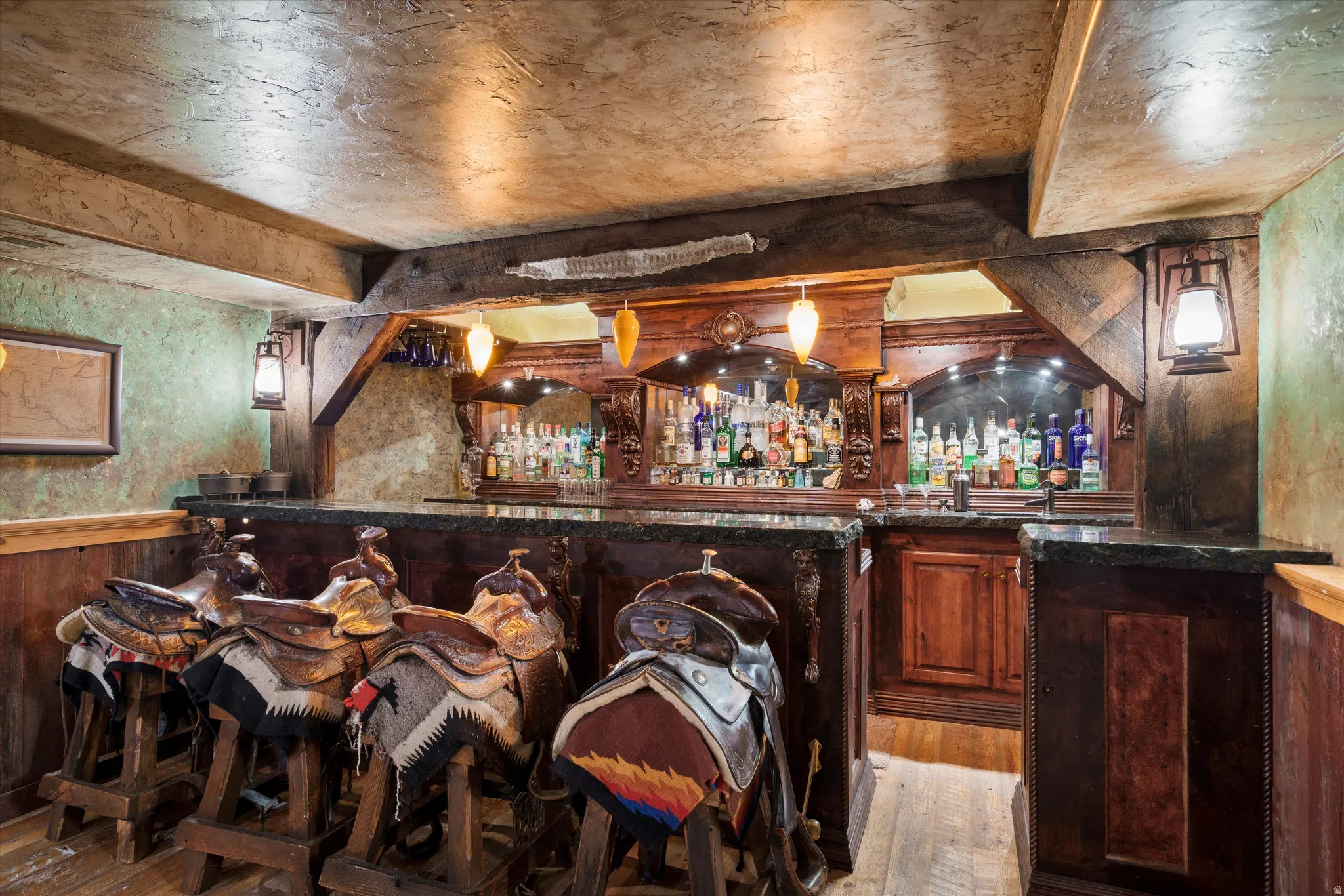 Custom bar area featuring wood-finish flooring, stone-finish walls, and wood paneling