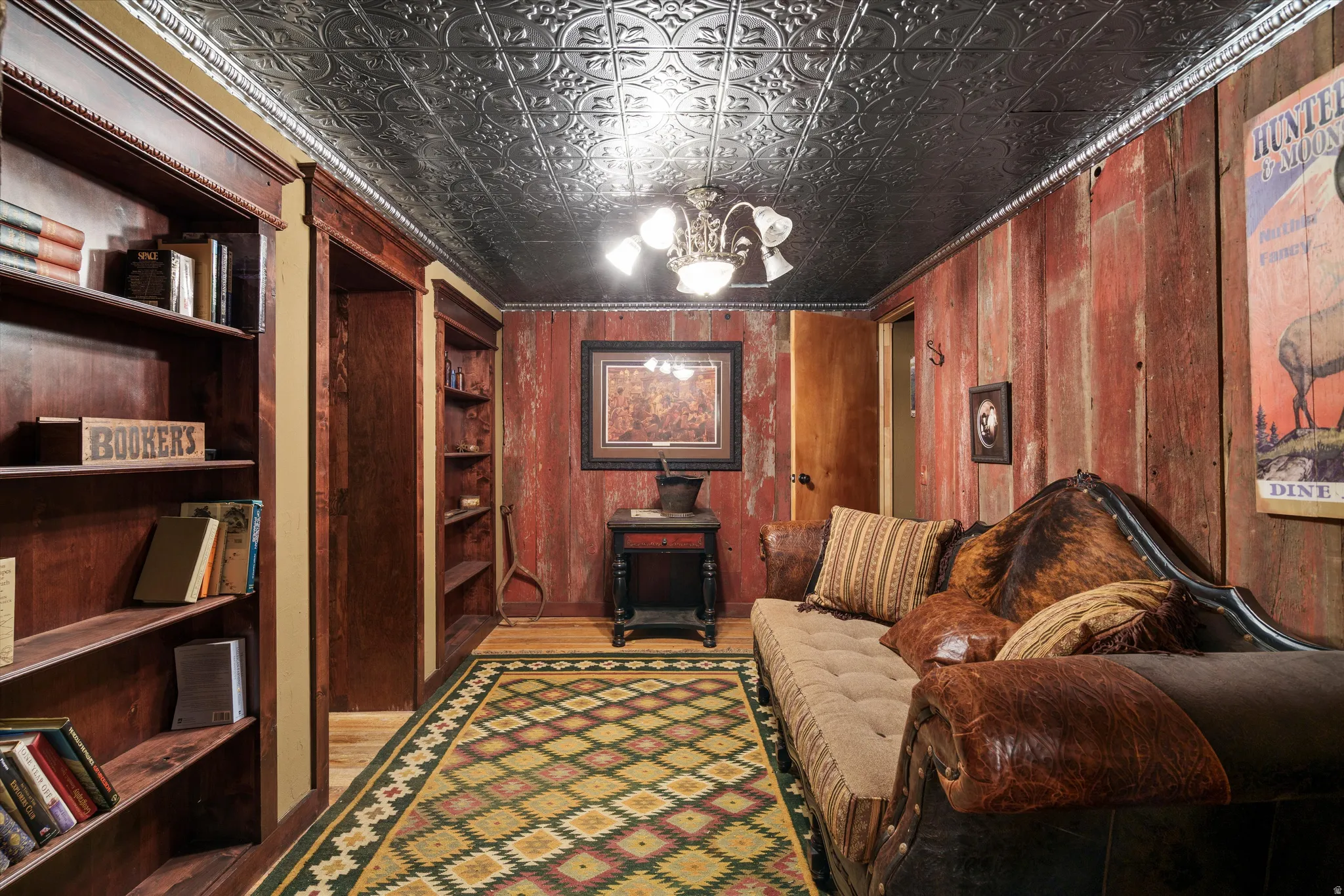 Reclaimed wood paneling accent wall with a metal embossed ceiling