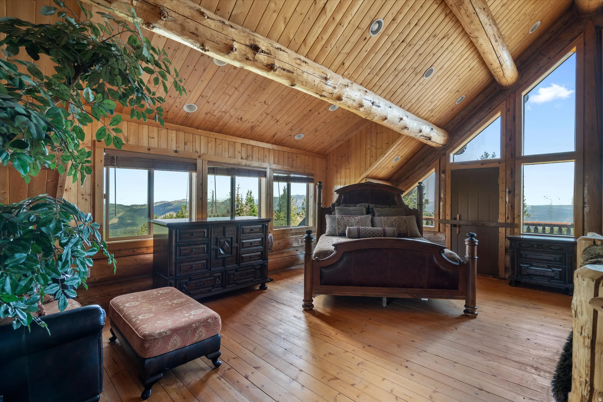 Vaulted wood-paneled ceiling with exposed log beams