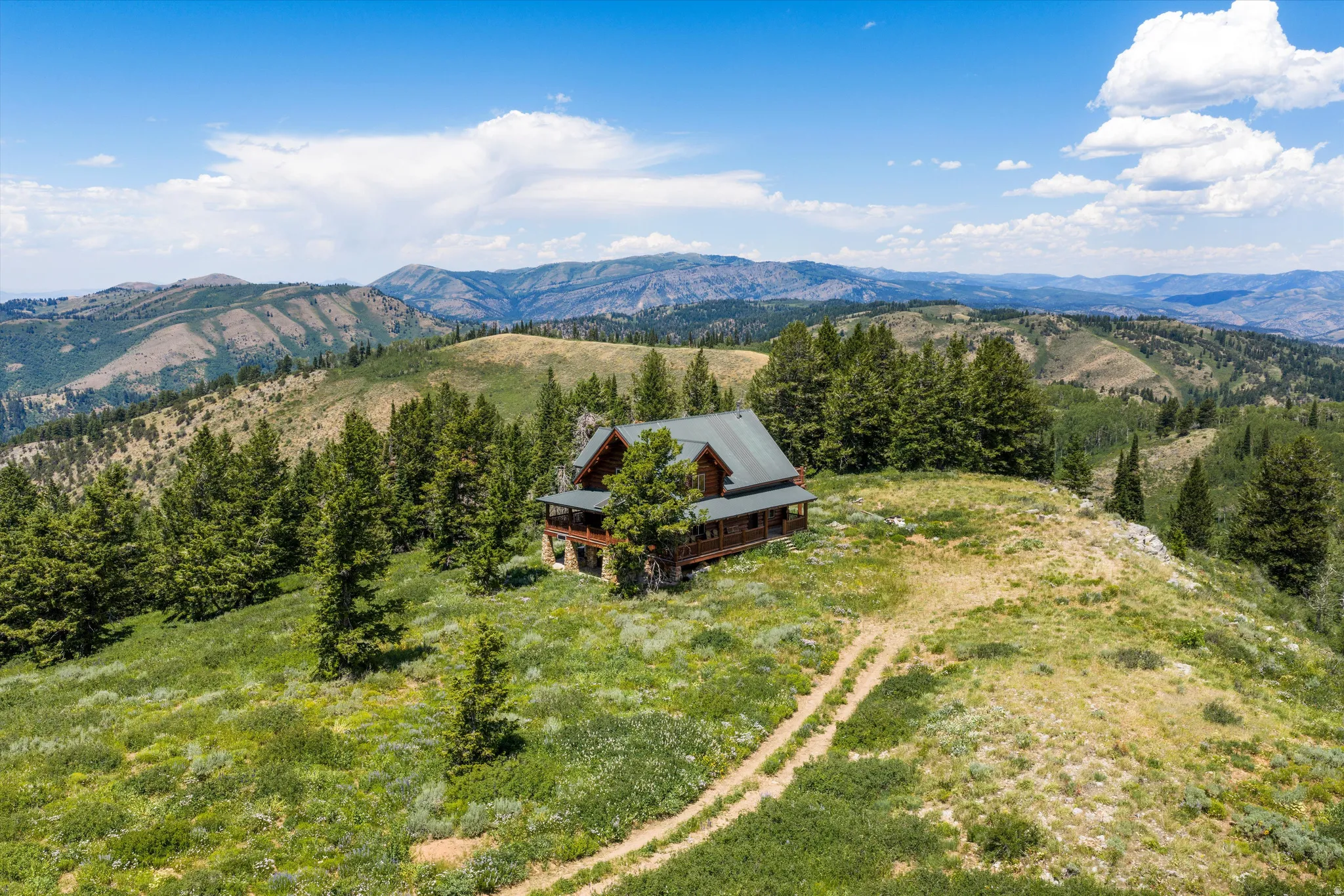 Log cabin residence set amidst a mountainous landscape with mature evergreen trees
