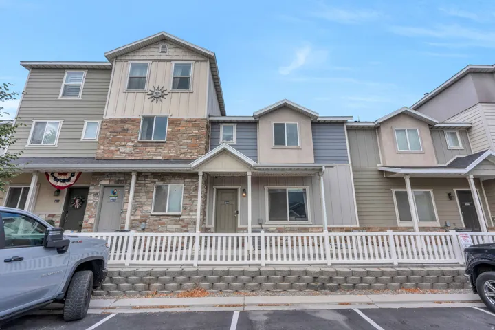 Multi-level townhome exterior featuring stone veneer and horizontal siding