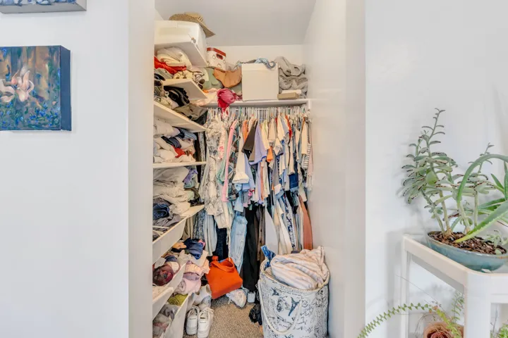 Built-in closet system featuring multiple shelving units and hanging rods
