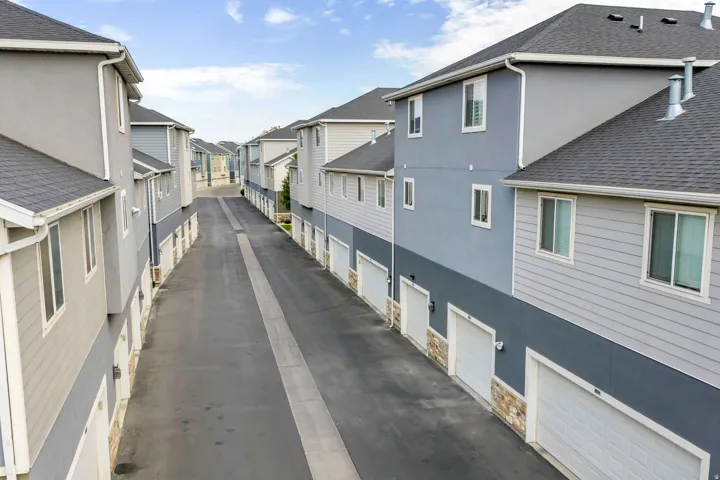 Row of townhomes featuring multi-level exteriors with contrasting siding and stucco finishes