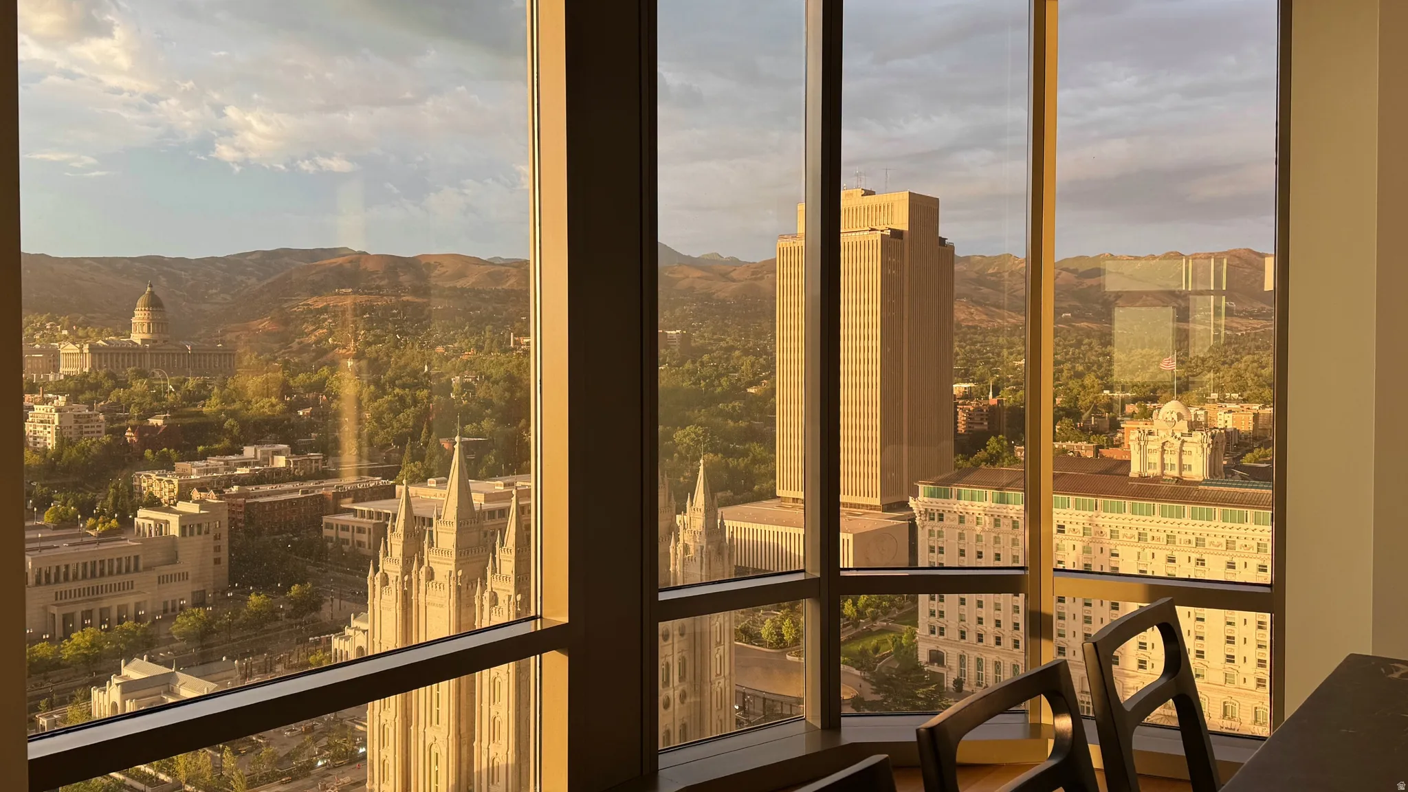 Panoramic windows showcasing cityscape and mountain scenery