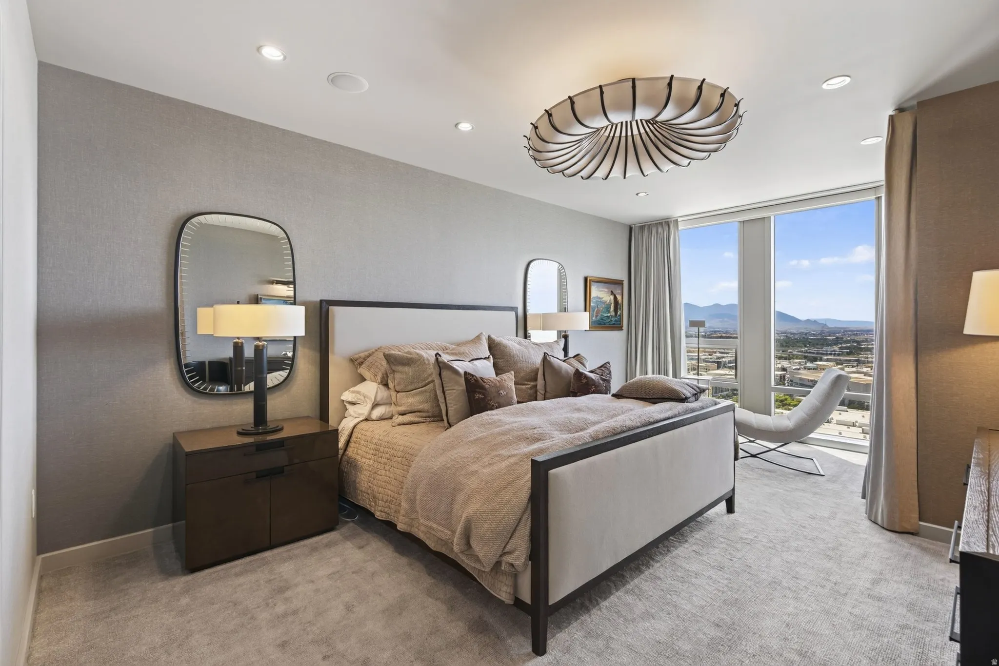 Expansive window wall with mountain and city scenery