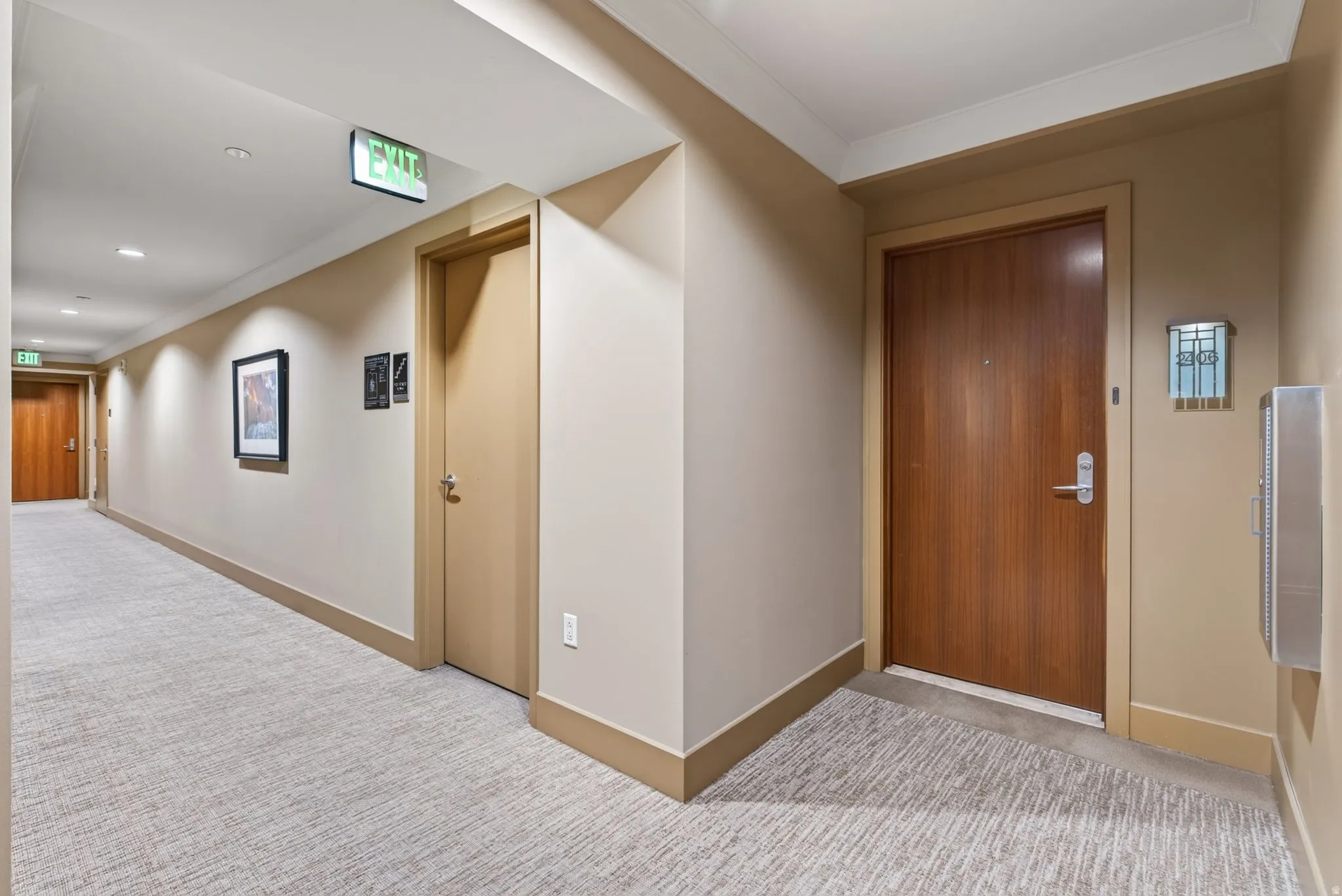 Building corridor featuring recessed lighting and wall sconces