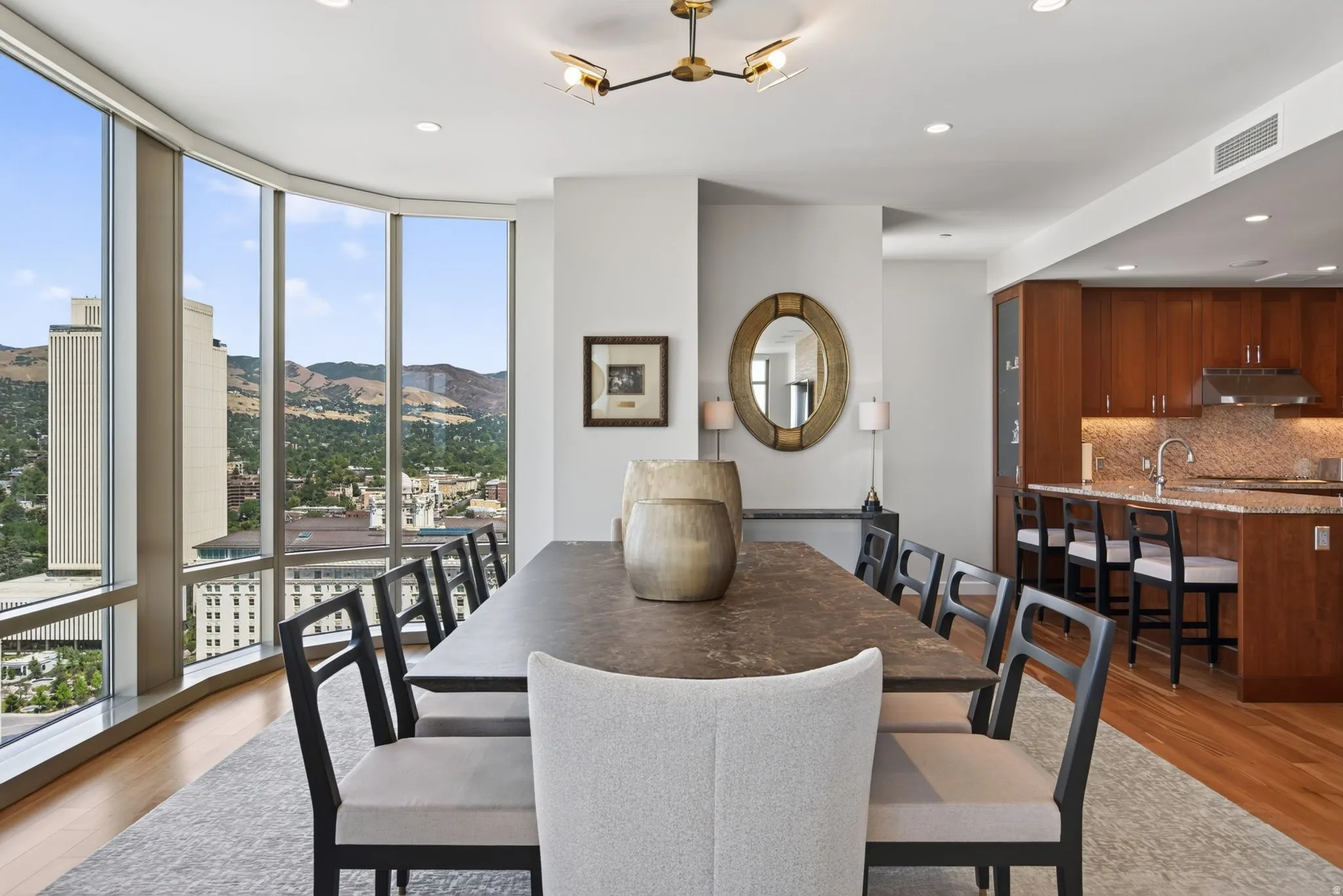 Spacious dining area featuring floor-to-ceiling windows, wood-finish flooring, and recessed lighting