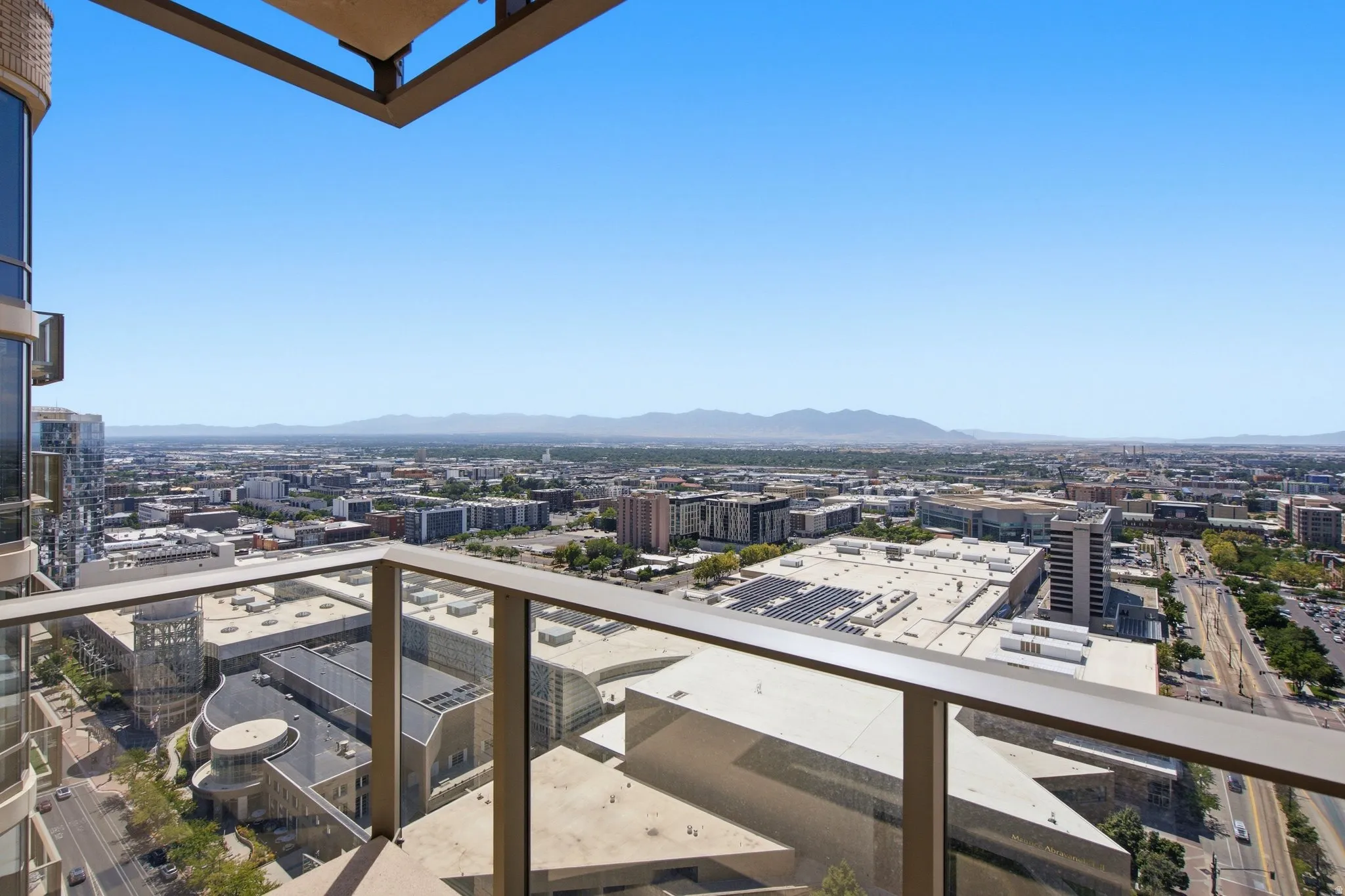 Expansive city panorama featuring distant mountains