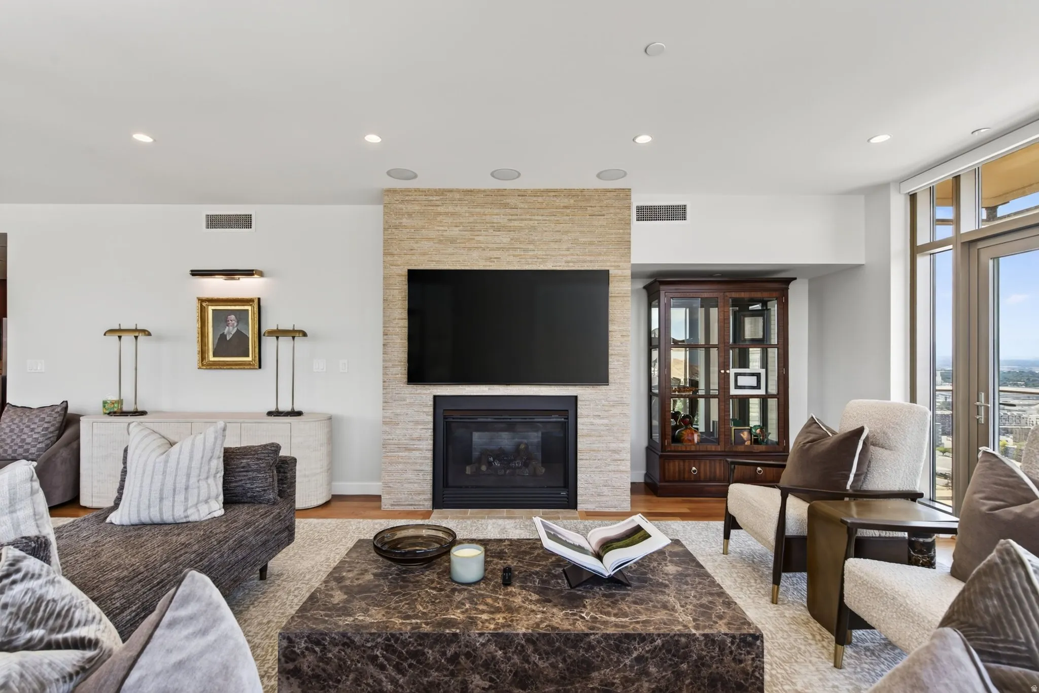 Living area with a stone-clad fireplace and integrated television