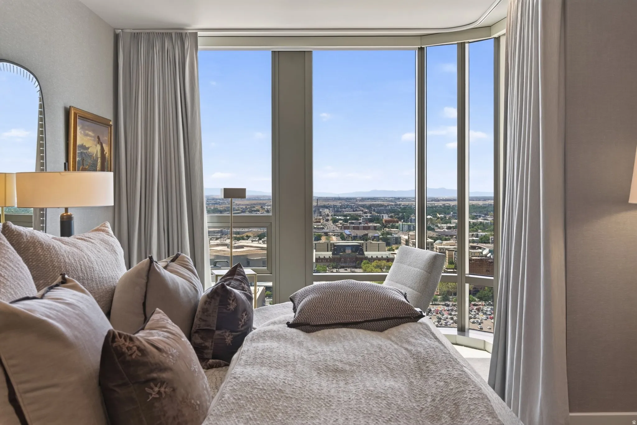 Floor-to-ceiling windows with expansive city and distant mountain scenery