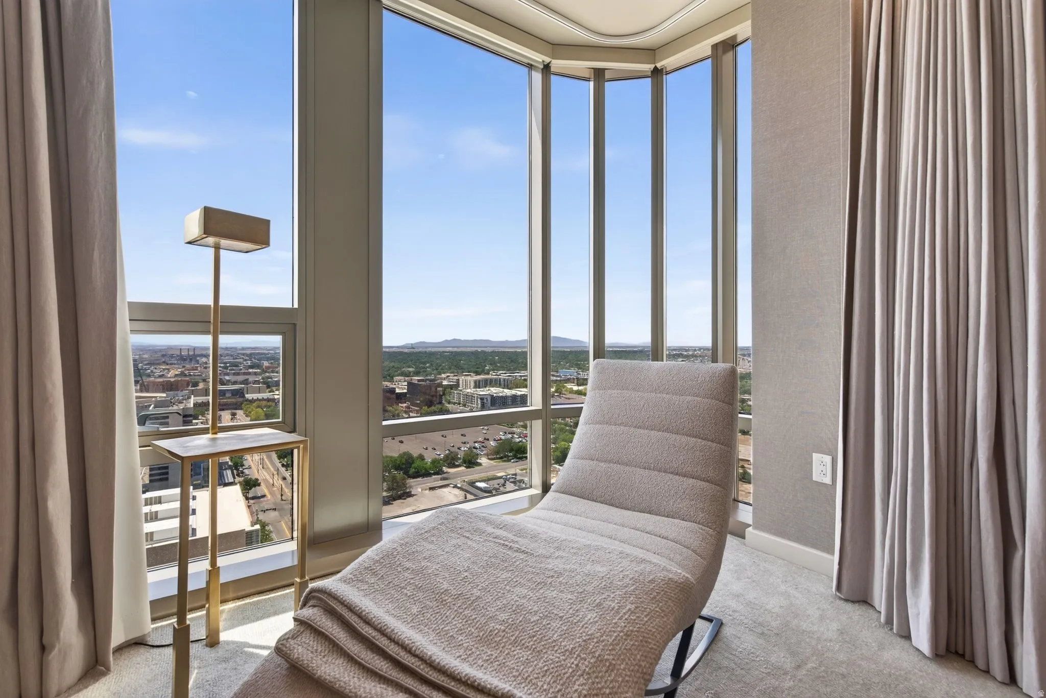 Floor-to-ceiling windows with expansive city and sky scenery
