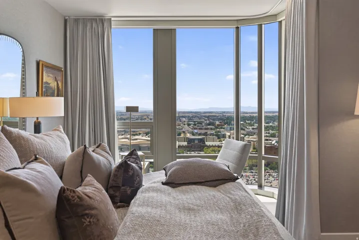 Floor-to-ceiling windows with expansive city and distant mountain scenery