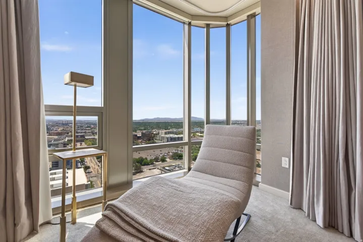 Floor-to-ceiling windows with expansive city and sky scenery
