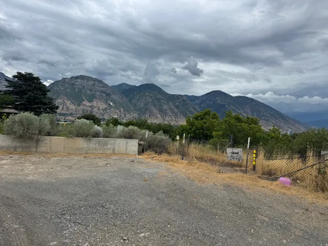 Expansive mountain scenery with a gravel lot