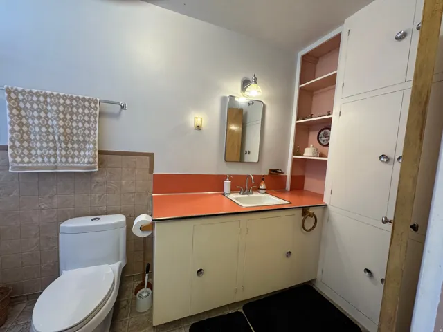 Bathroom featuring a built-in vanity with a countertop and integrated sink