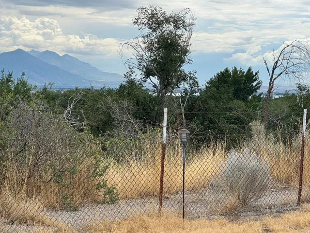 Expansive mountain range backdrop with distant city elements