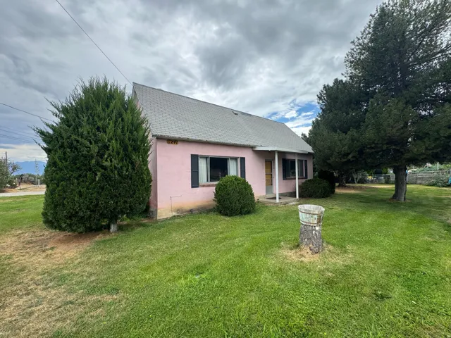 Pink stucco exterior featuring a covered porch entry