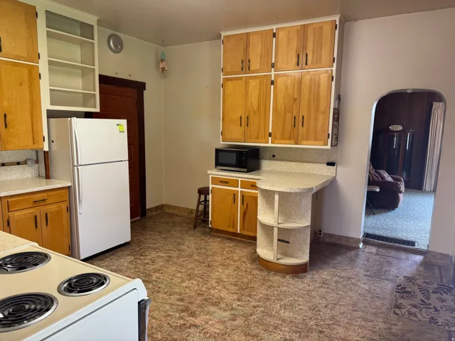 Kitchen featuring light wood cabinetry and countertops