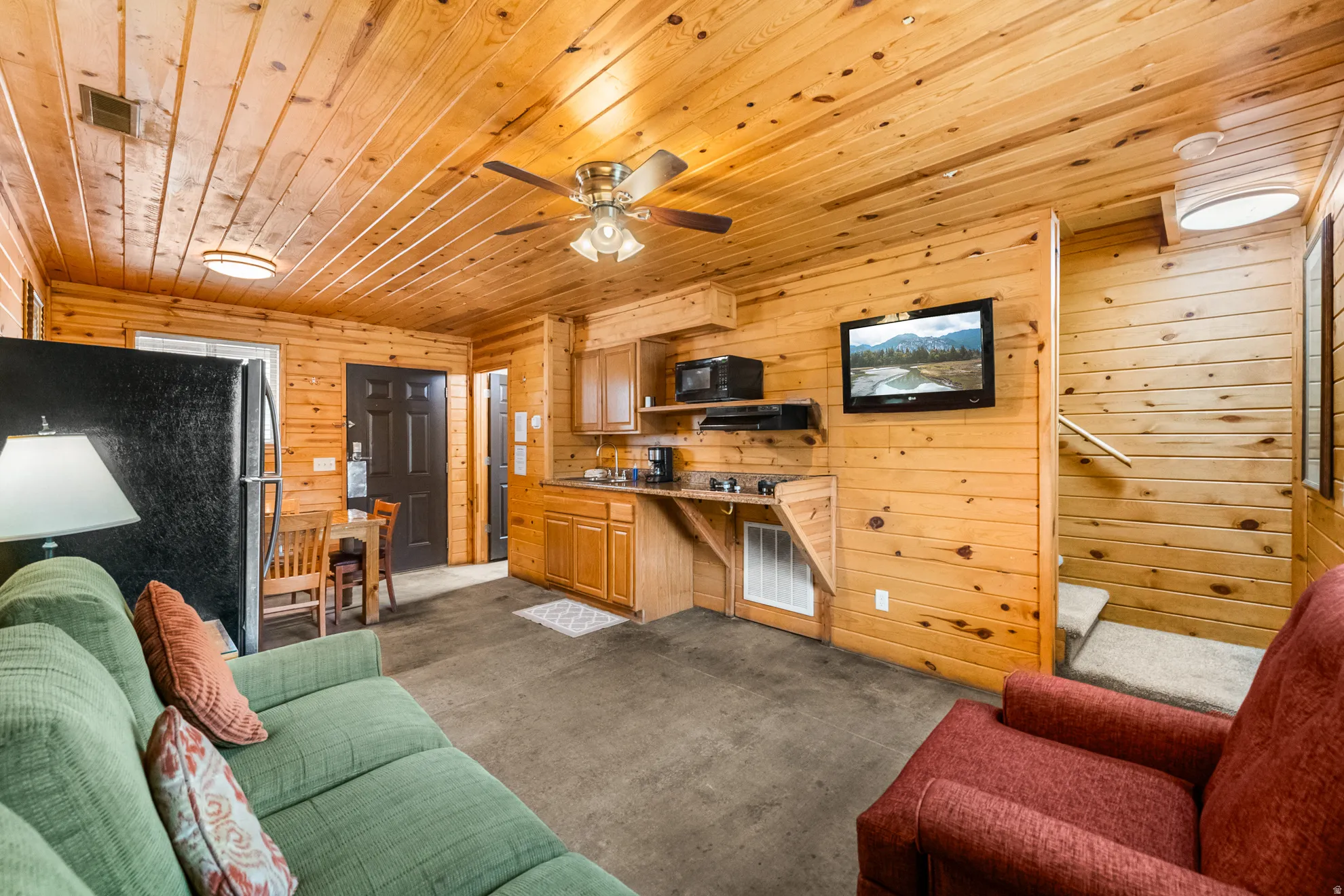 Warm interior featuring wood-paneled walls and ceiling
