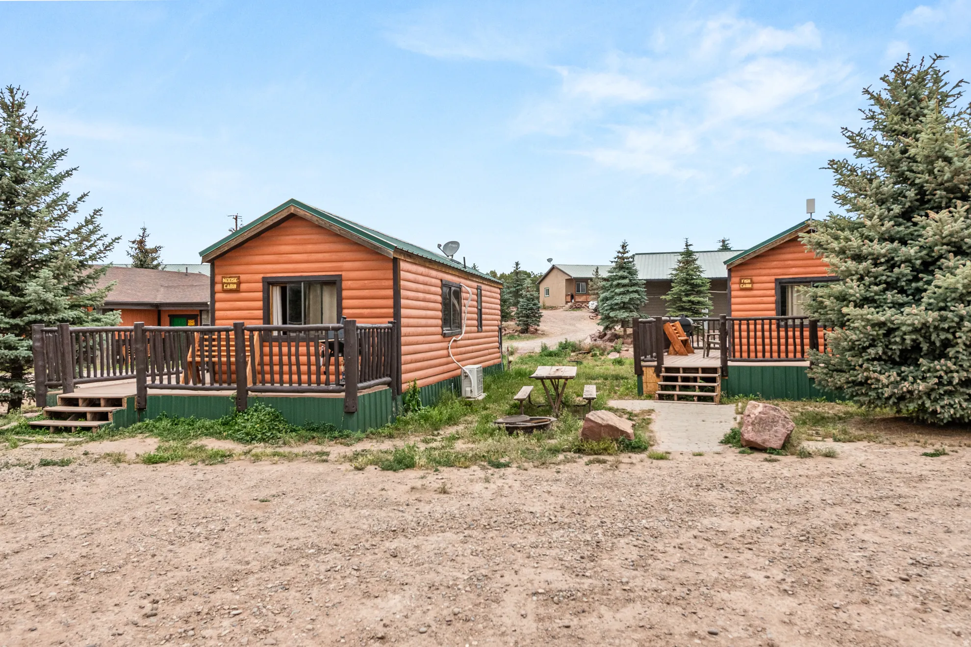 Log cabin style dwelling featuring a private exterior deck with dark wood railing