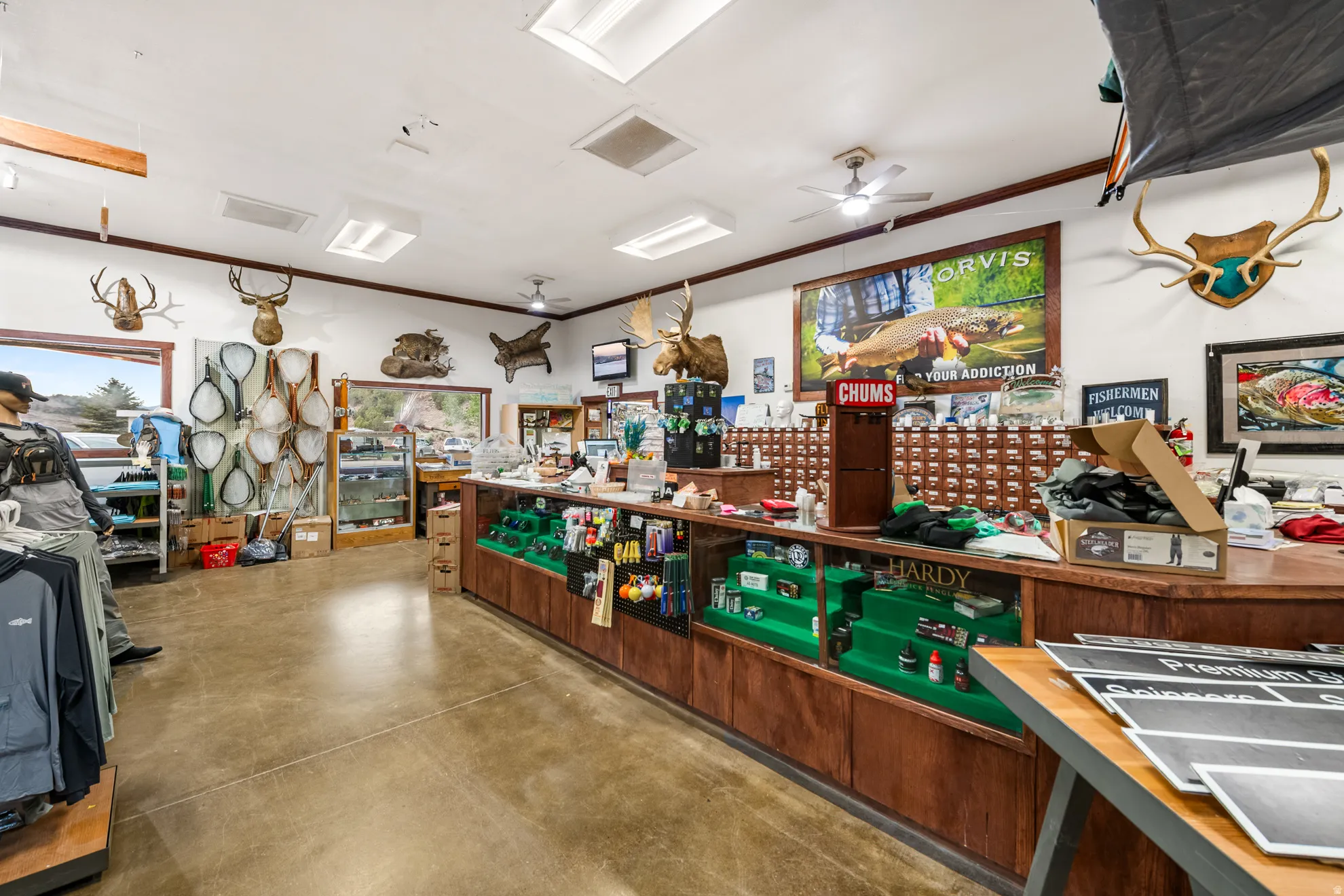 Retail interior featuring concrete flooring, extensive display cases, recessed lighting, and perimeter windows