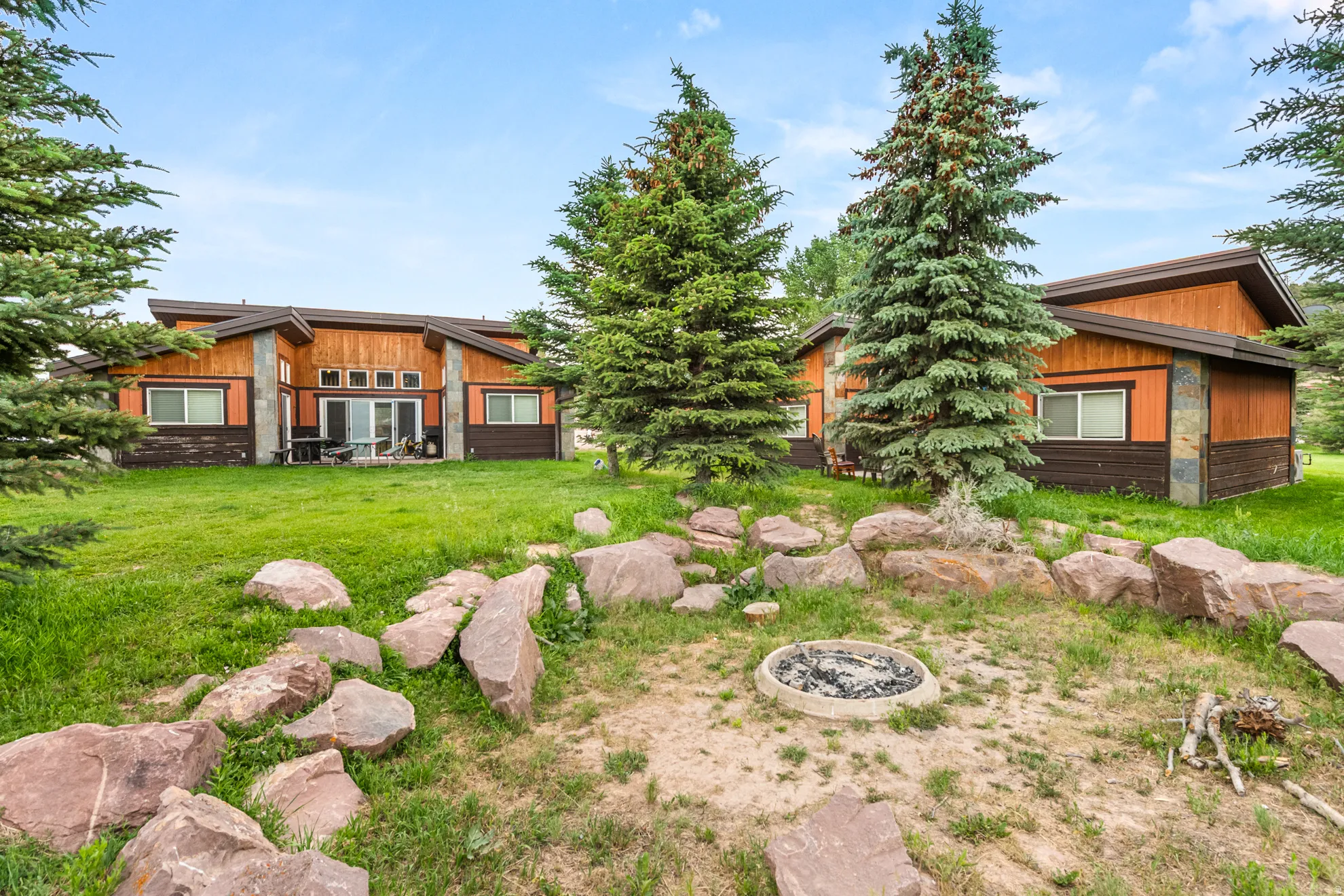 Two structures featuring wood-finish siding and stone accents