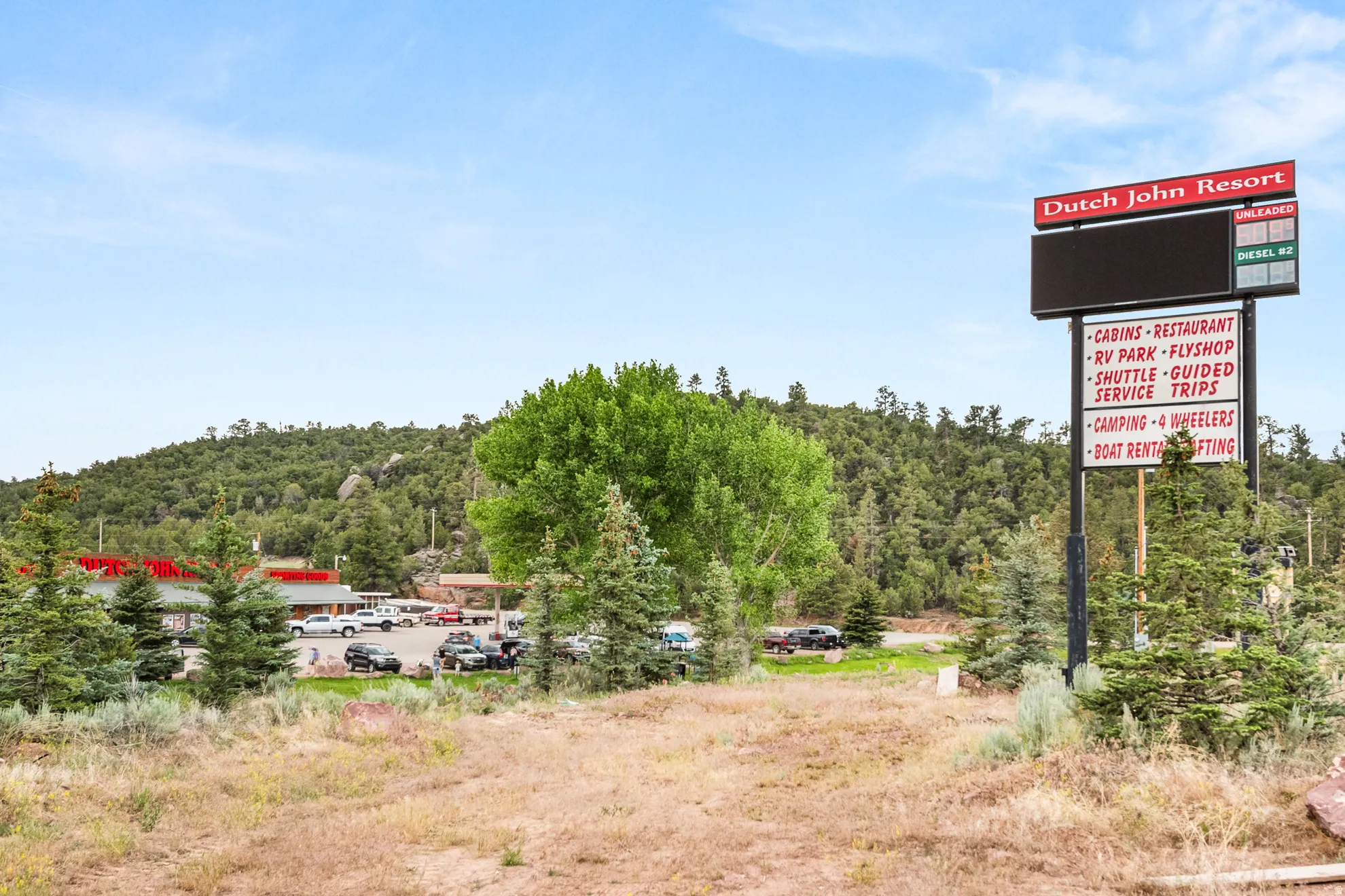 Resort signage featuring a digital display and listed amenities