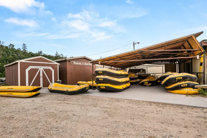 Uncovered storage area featuring a sloped, open-beam roof structure