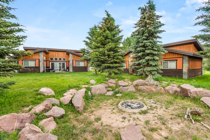 Two structures featuring wood-finish siding and stone accents