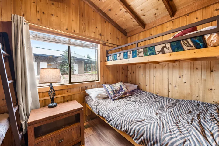 Wood-paneled room with exposed ceiling beams and wood-finish flooring