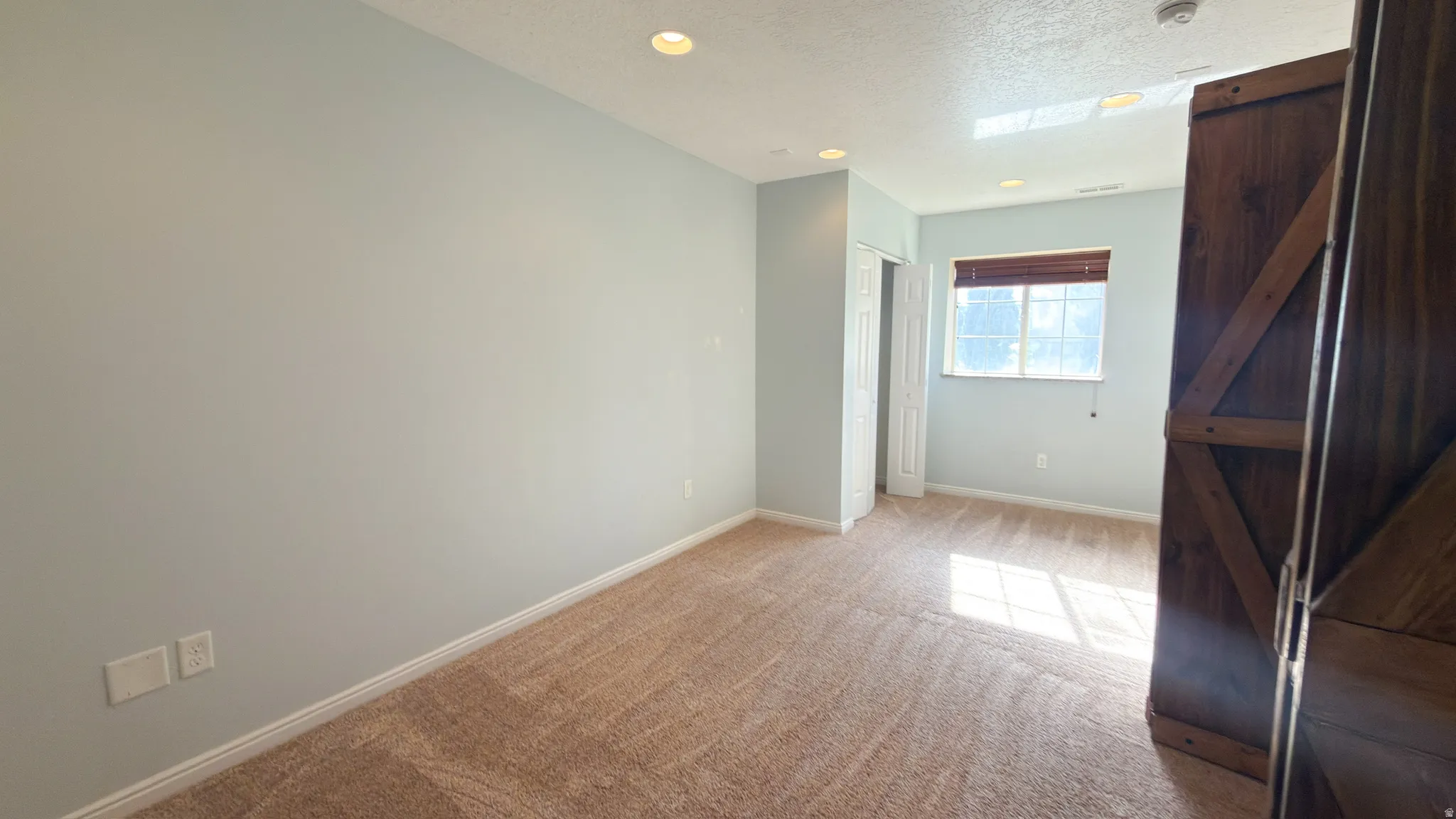 Carpeted room with recessed lighting and a skylight