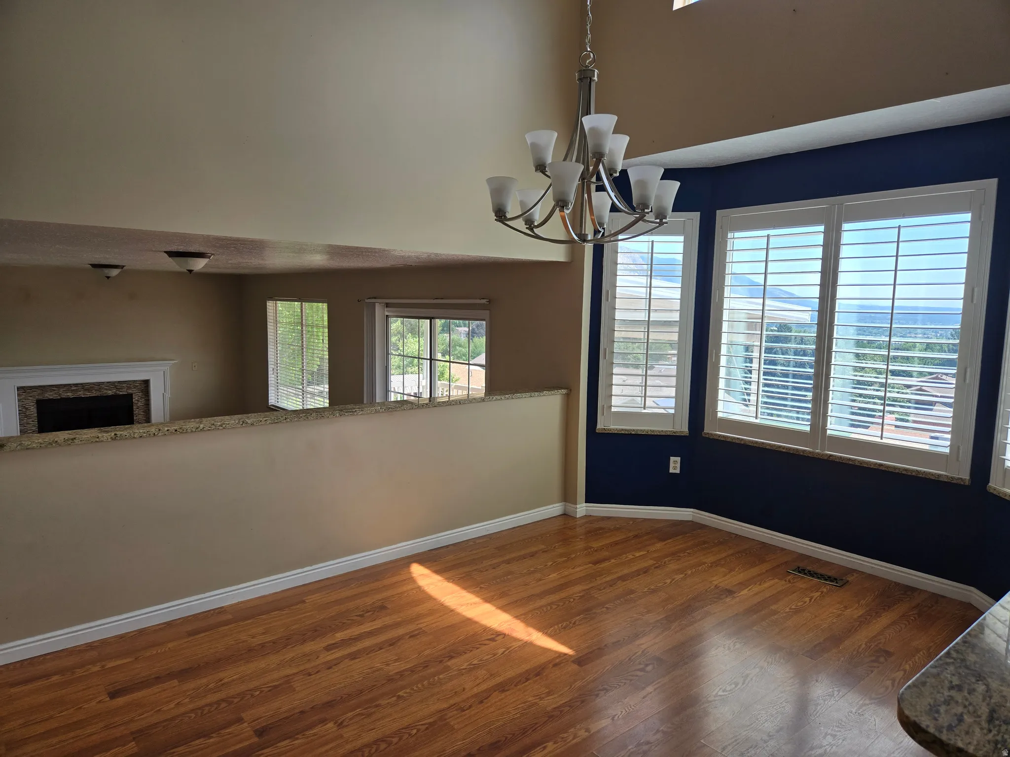 Dining area featuring wood-finish flooring and a contemporary chandelier