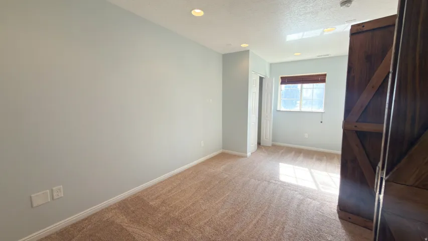 Carpeted room with recessed lighting and a skylight