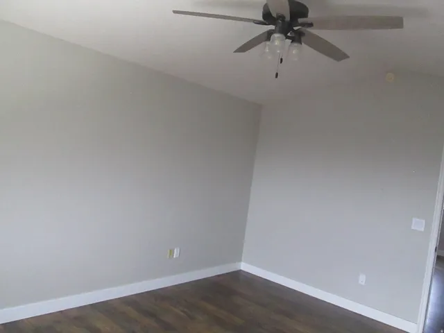Master Bedroom, neutral-toned walls, wood-finish flooring, and a ceiling fan with integrated lighting