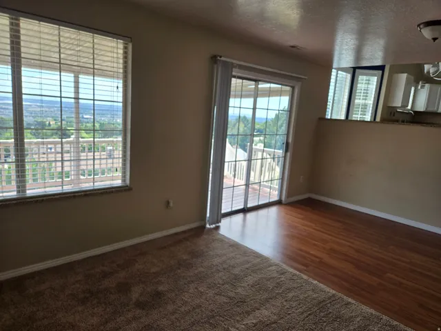 Interior space featuring a large window and sliding glass door leading to an outdoor deck