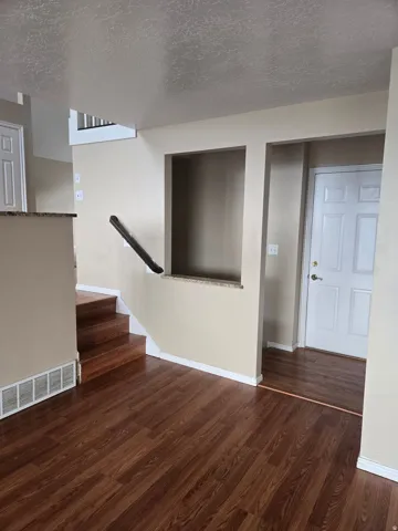 Rich wood-finish flooring extends through the main level