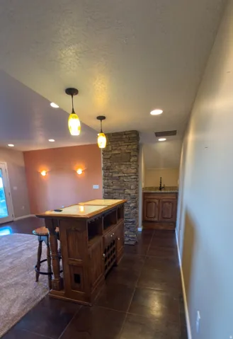 Wood-finish bar with integrated wine storage and tile countertop