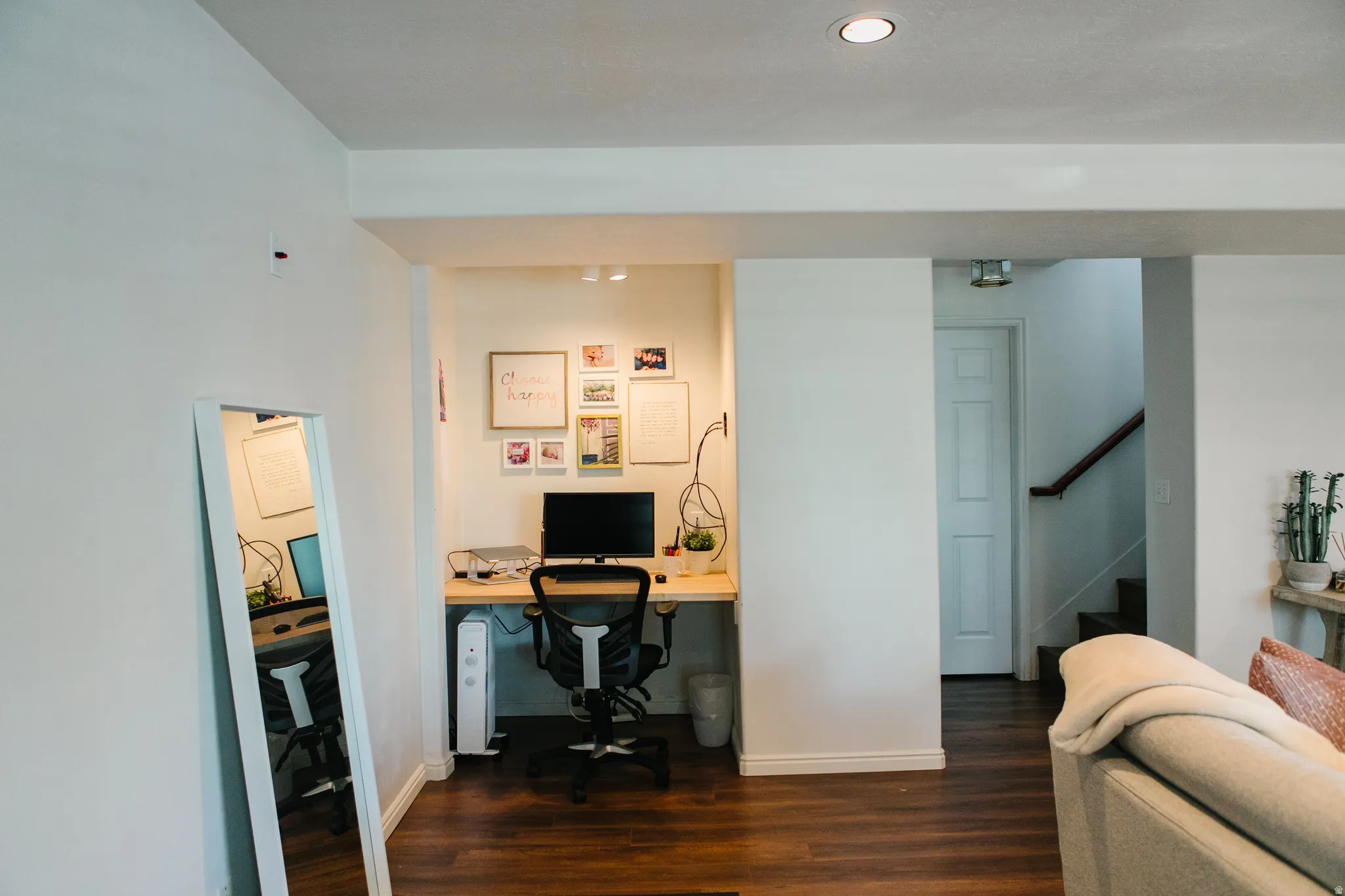 Dedicated desk nook featuring a built-in wood-finish desktop, overhead recessed lighting, and wall-mounted track lighting