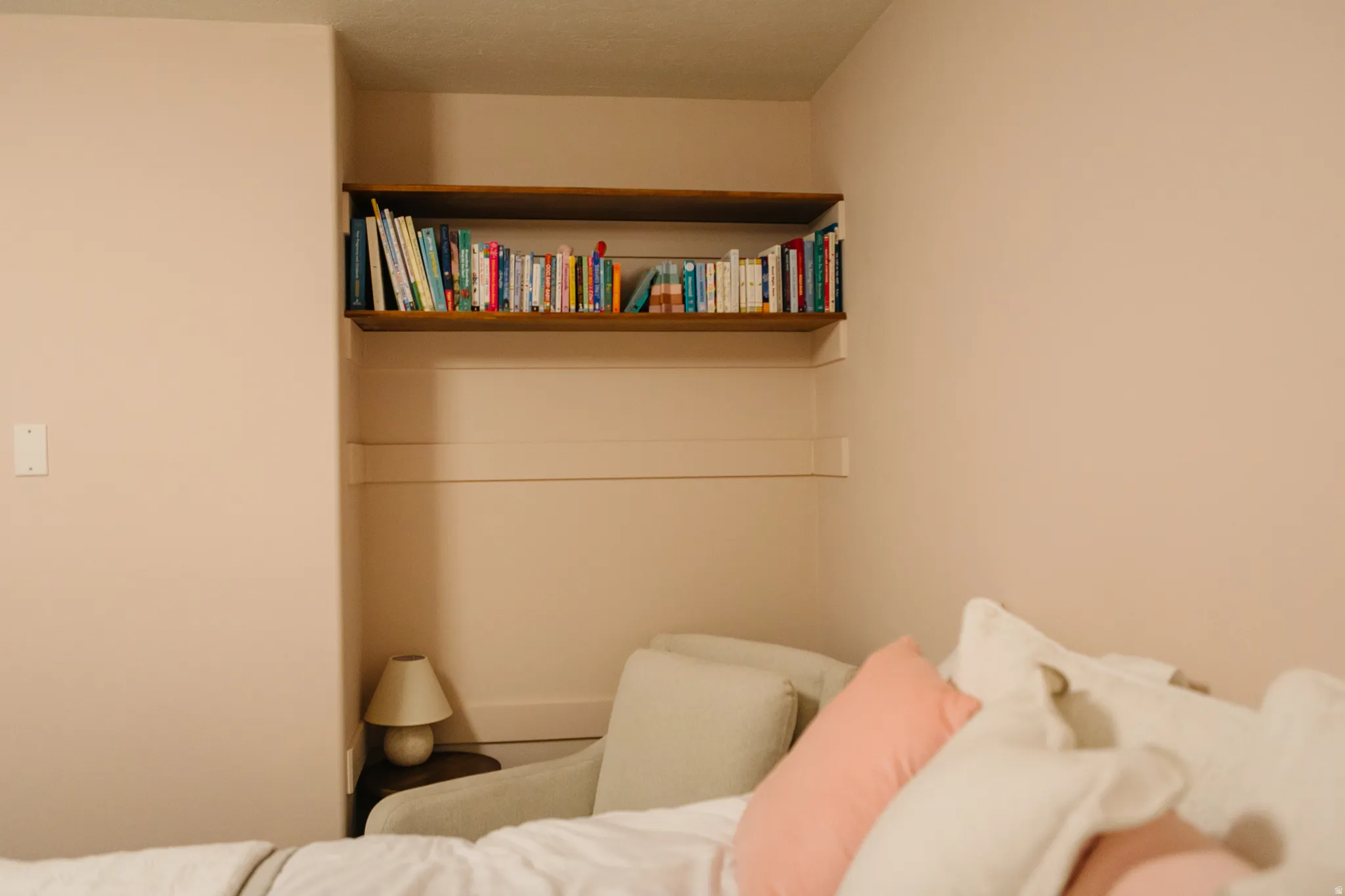 Built-in shelving with wood-finish top shelf and recessed wall paneling