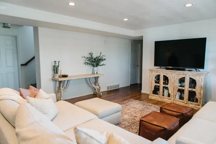 Spacious living area featuring recessed lighting, light wood-finish flooring, and white painted walls