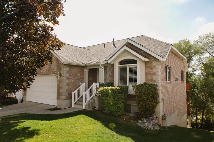 Brick exterior with stone accents and a gabled roofline