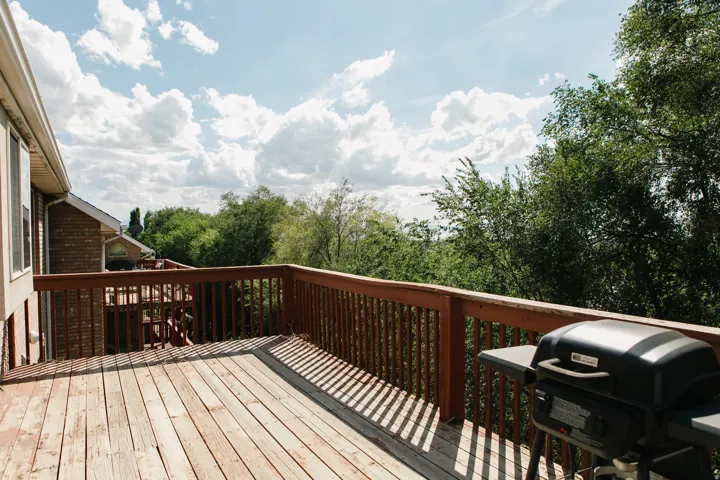 Expansive wooden deck featuring perimeter railing and ample space for outdoor enjoyment plus views