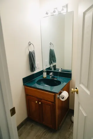 Bathroom vanity with a dark teal countertop and integrated sink