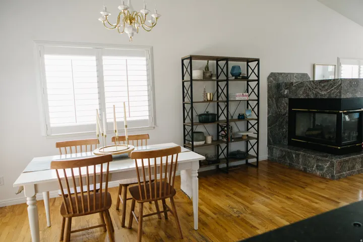 Spacious interior featuring wood flooring, a vaulted ceiling, and a fireplace