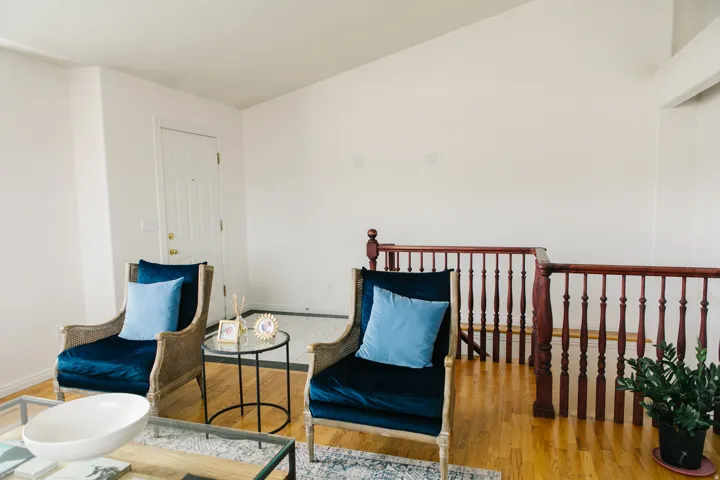 Bright living area featuring wood-finish flooring and a vaulted ceiling